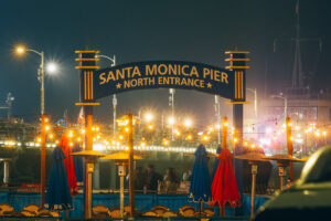 Illuminated Santa Monica Pier north entrance sign at night