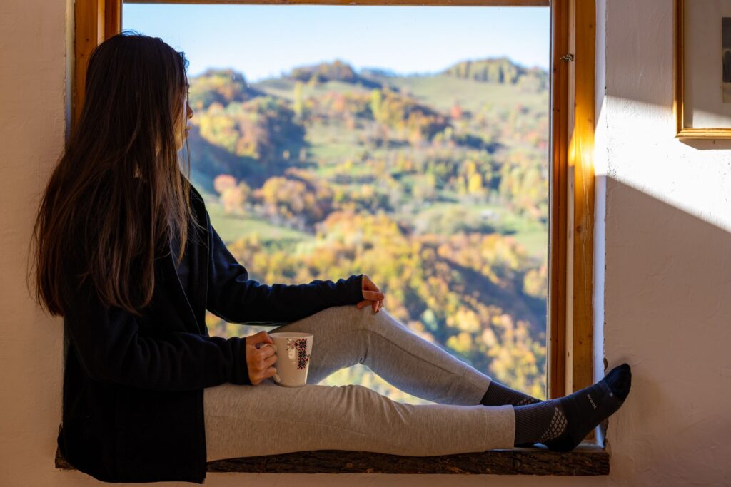 with a Mug by the Open Window